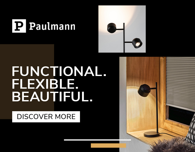 Paulmann modern black adjustable lamp shown both mounted on a wall and standing on a wooden windowsill, highlighting its functional and flexible design.